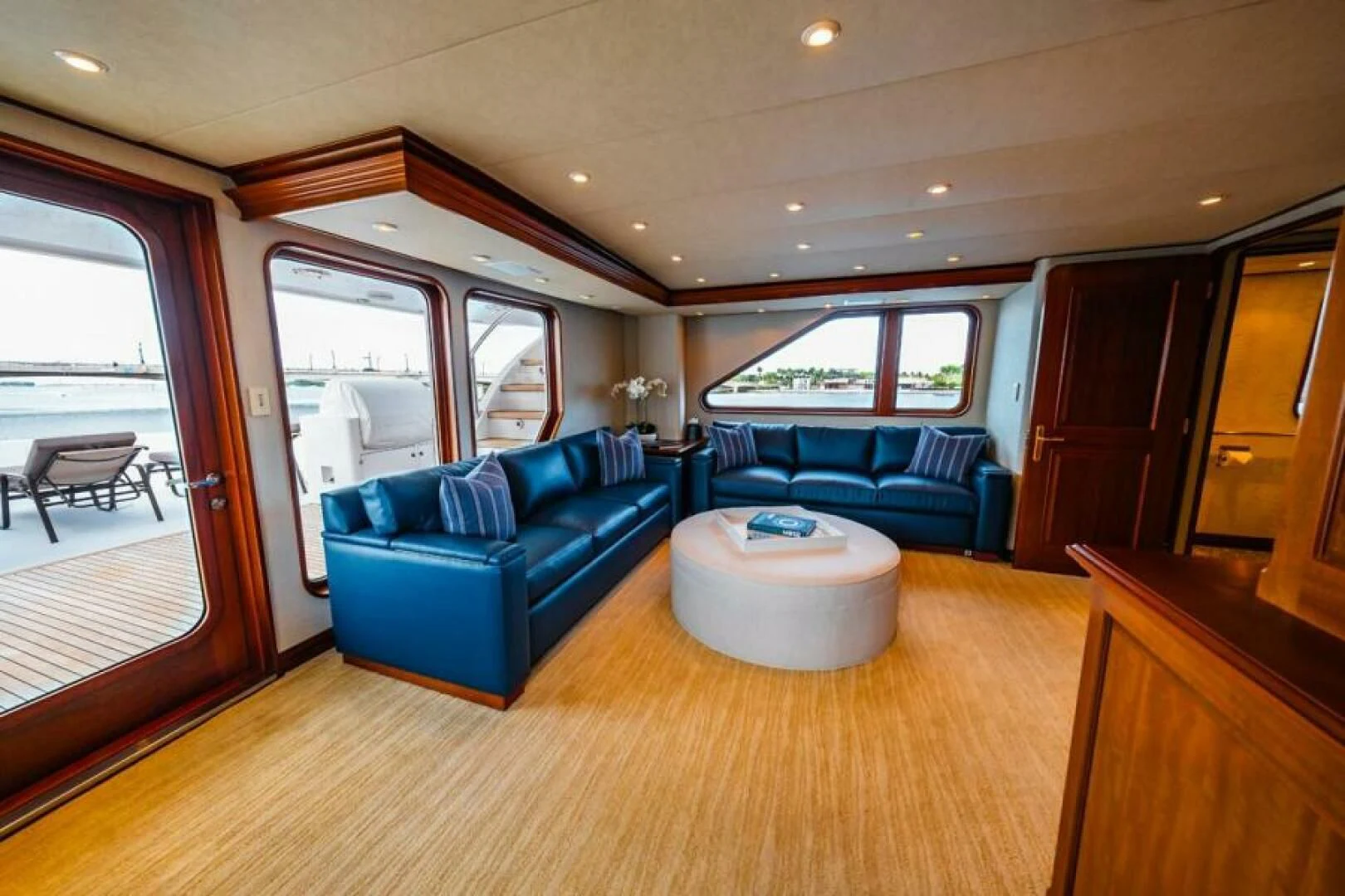 a living room with a blue couch aboard LEGACY Yacht for Sale