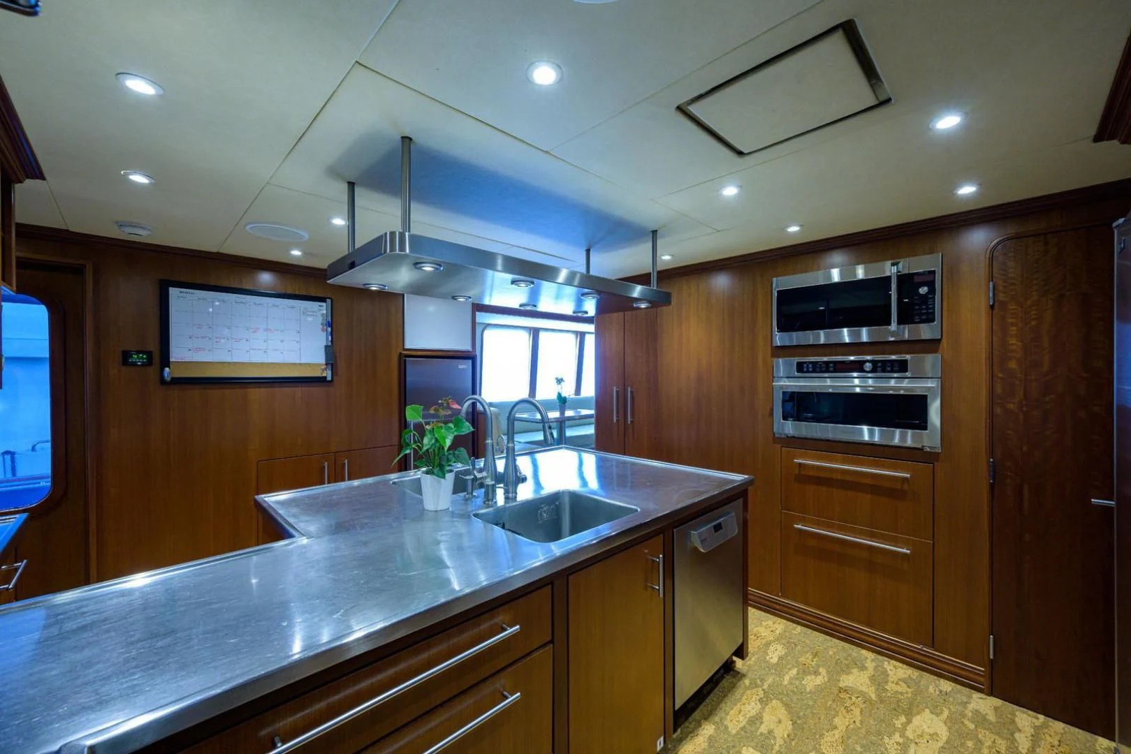 a kitchen with wooden cabinets aboard LEGACY Yacht for Sale