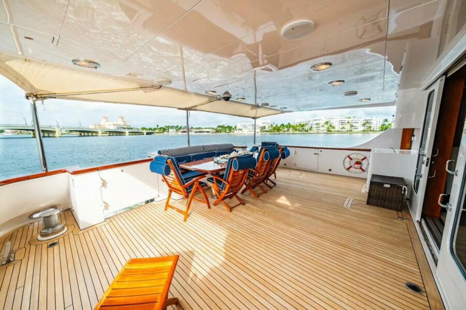 a large room with a table and chairs and a pool aboard LEGACY Yacht for Sale