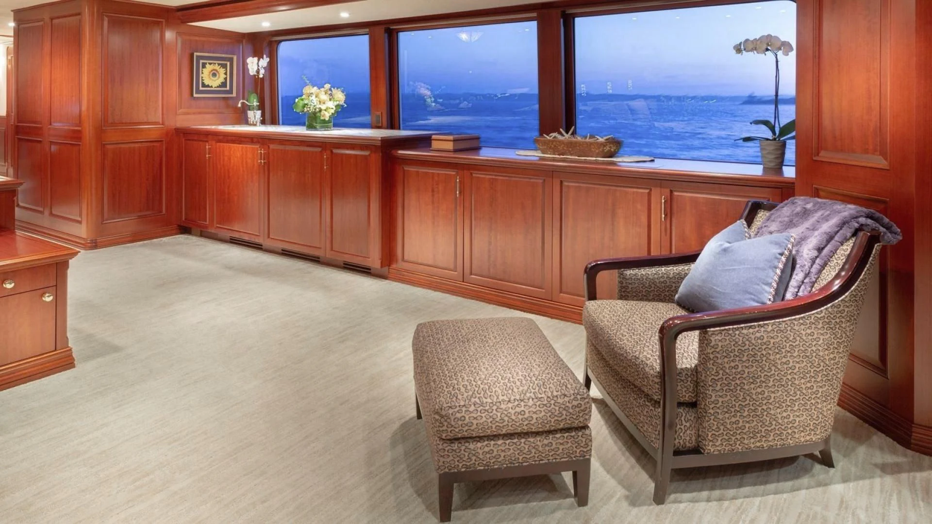 a room with a chair and a table and a window aboard LEGACY Yacht for Sale