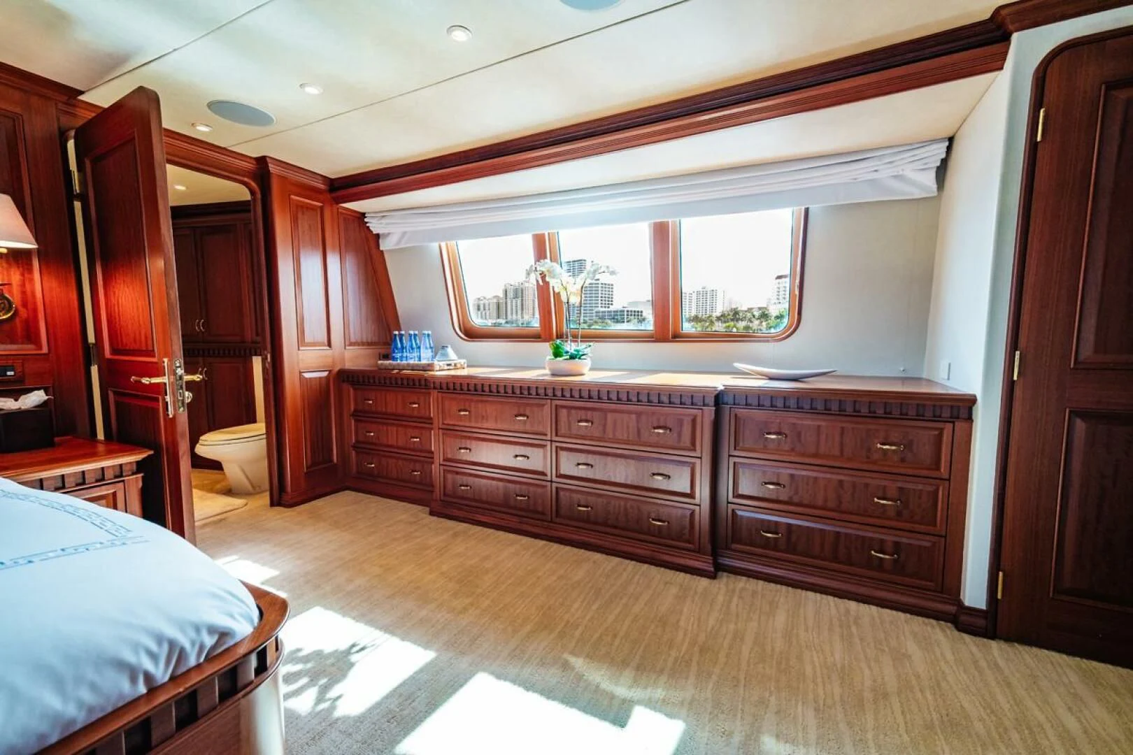 a bedroom with a bed and a dresser aboard LEGACY Yacht for Sale
