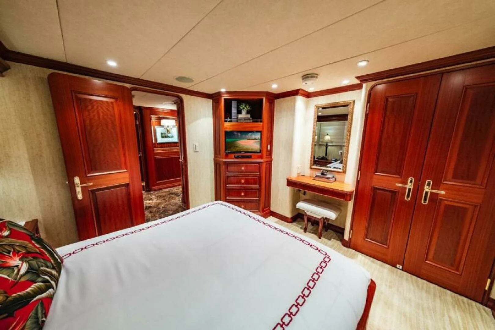 a bedroom with a bed and desk aboard LEGACY Yacht for Sale