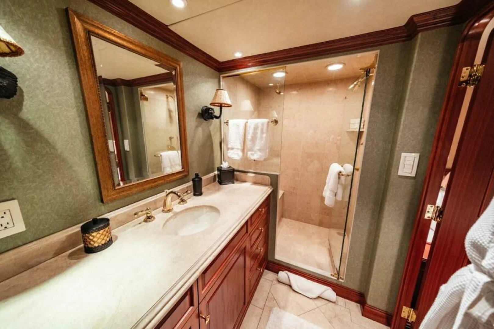 a bathroom with a countertop sink and mirror aboard LEGACY Yacht for Sale