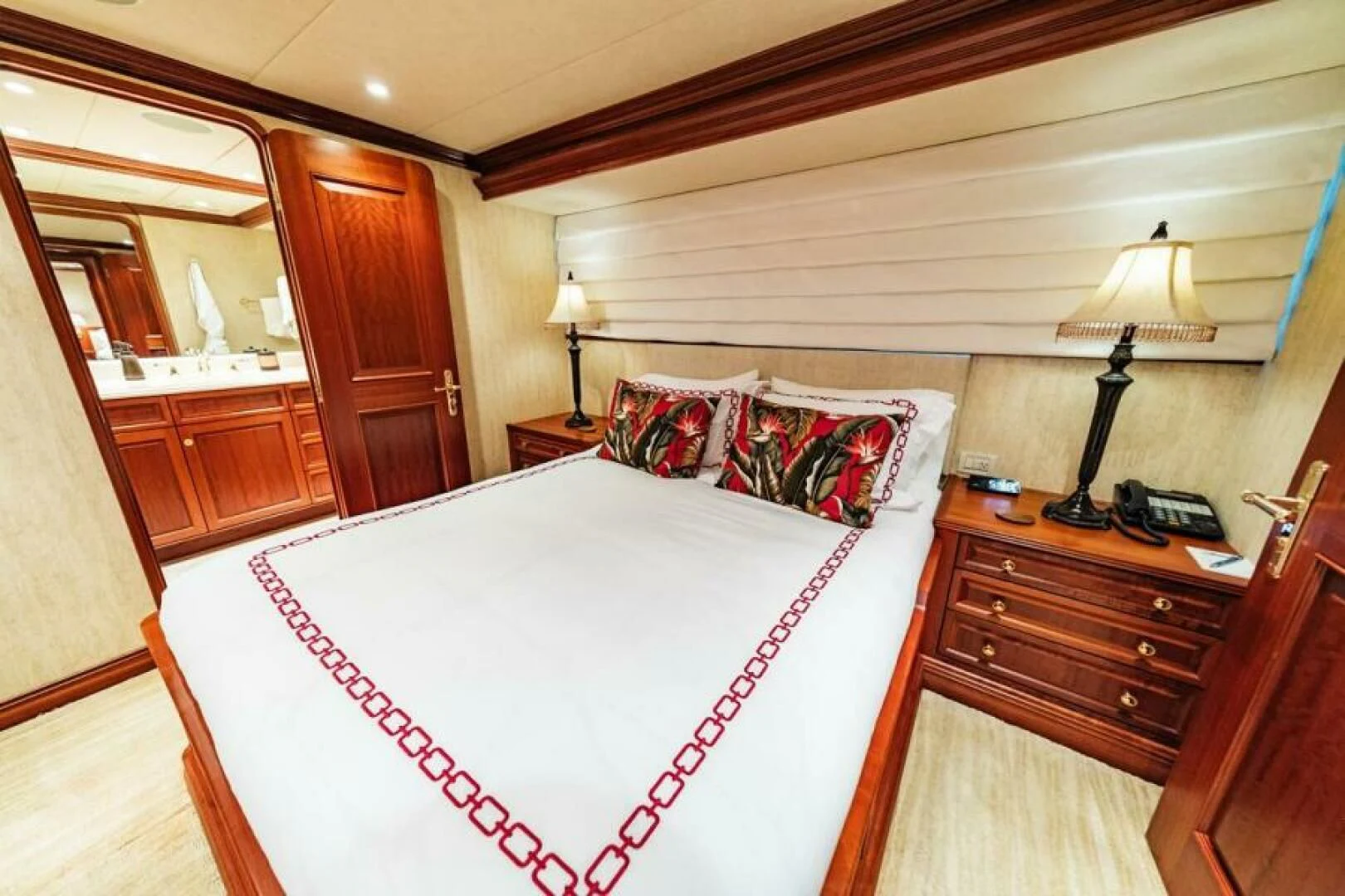 a bedroom with a bed and a dresser aboard LEGACY Yacht for Sale