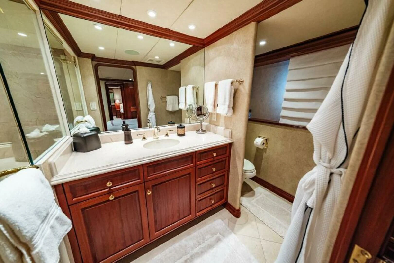 a bathroom with a large mirror aboard LEGACY Yacht for Sale