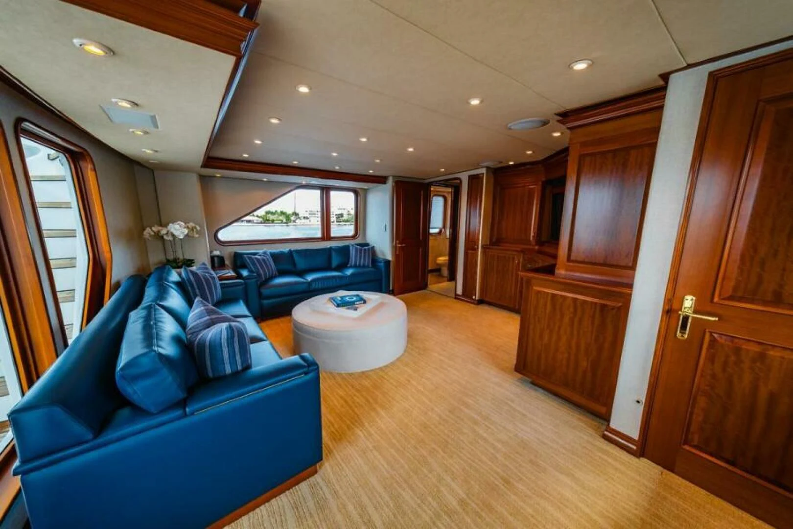 a living room with a couch and a wood door aboard LEGACY Yacht for Sale