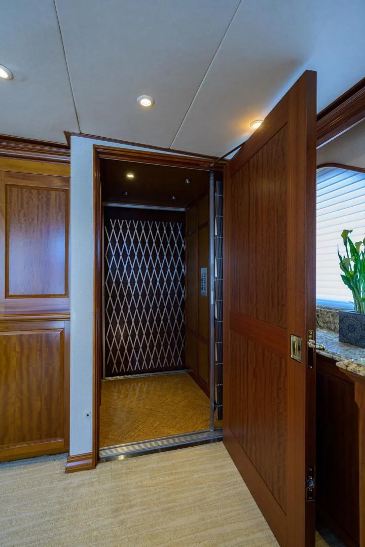 a room with wooden doors aboard LEGACY Yacht for Sale