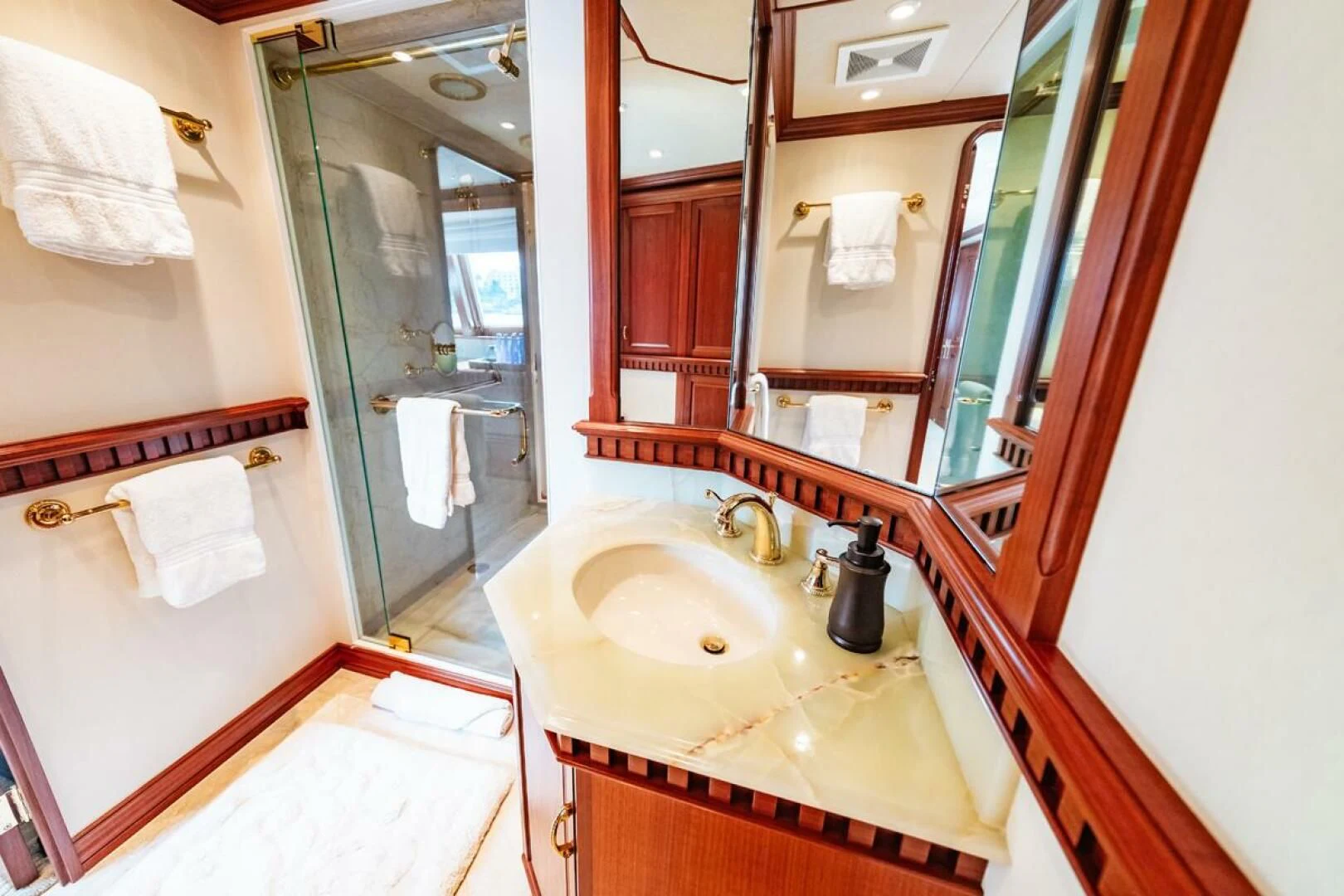 a bathroom with a sink and a mirror aboard LEGACY Yacht for Sale