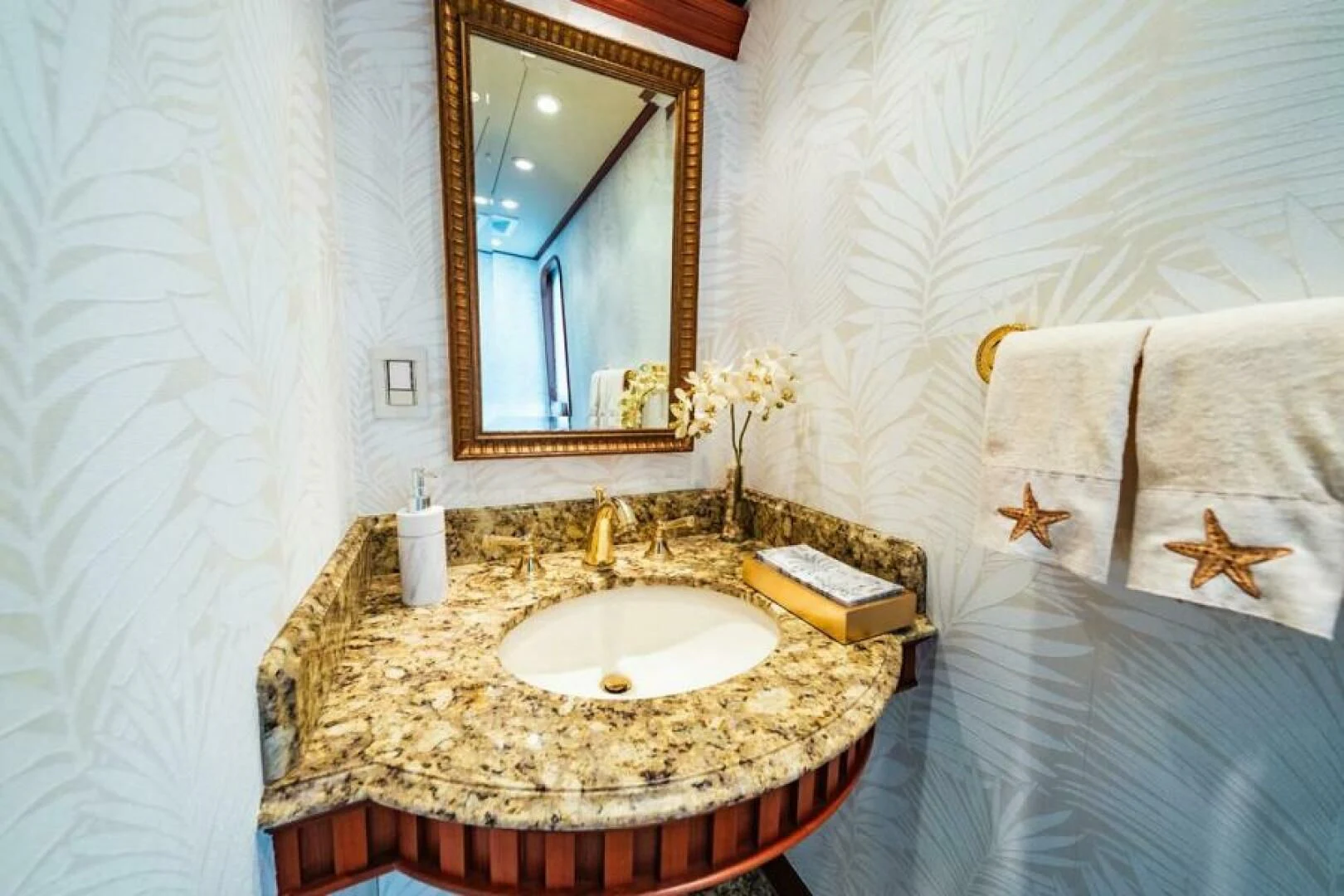 a bathroom with a marble countertop aboard LEGACY Yacht for Sale