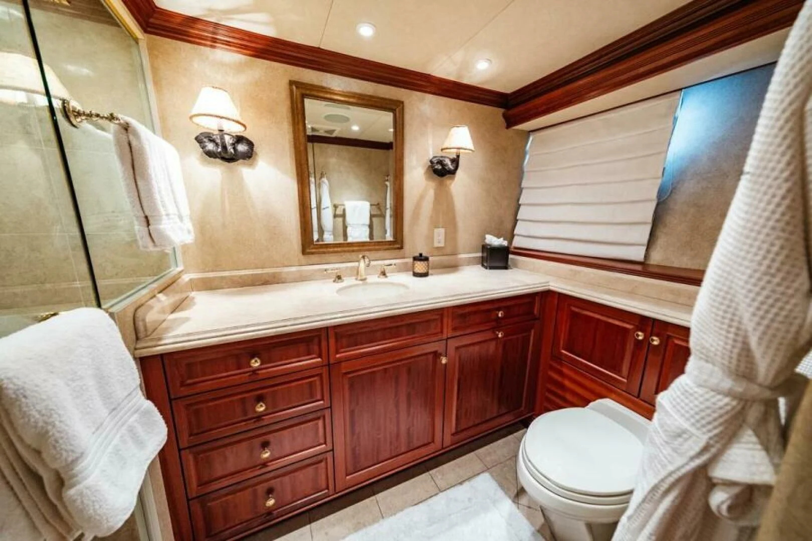 a bathroom with a large mirror aboard LEGACY Yacht for Sale