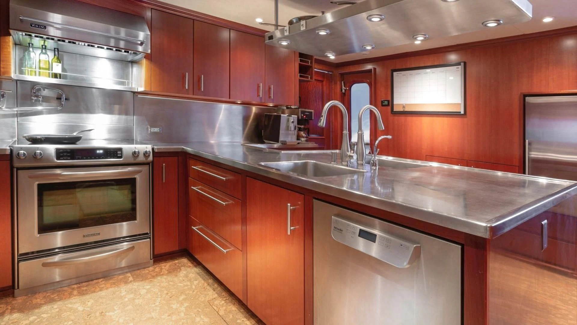 a kitchen with wooden cabinets aboard LEGACY Yacht for Sale