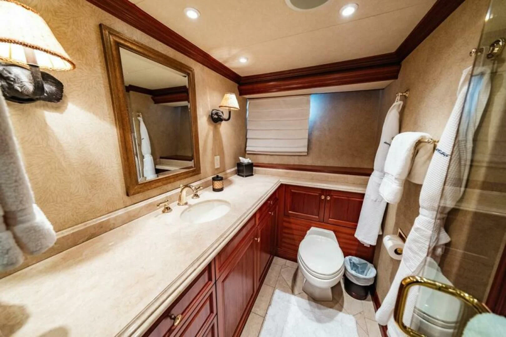a bathroom with a large mirror aboard LEGACY Yacht for Sale