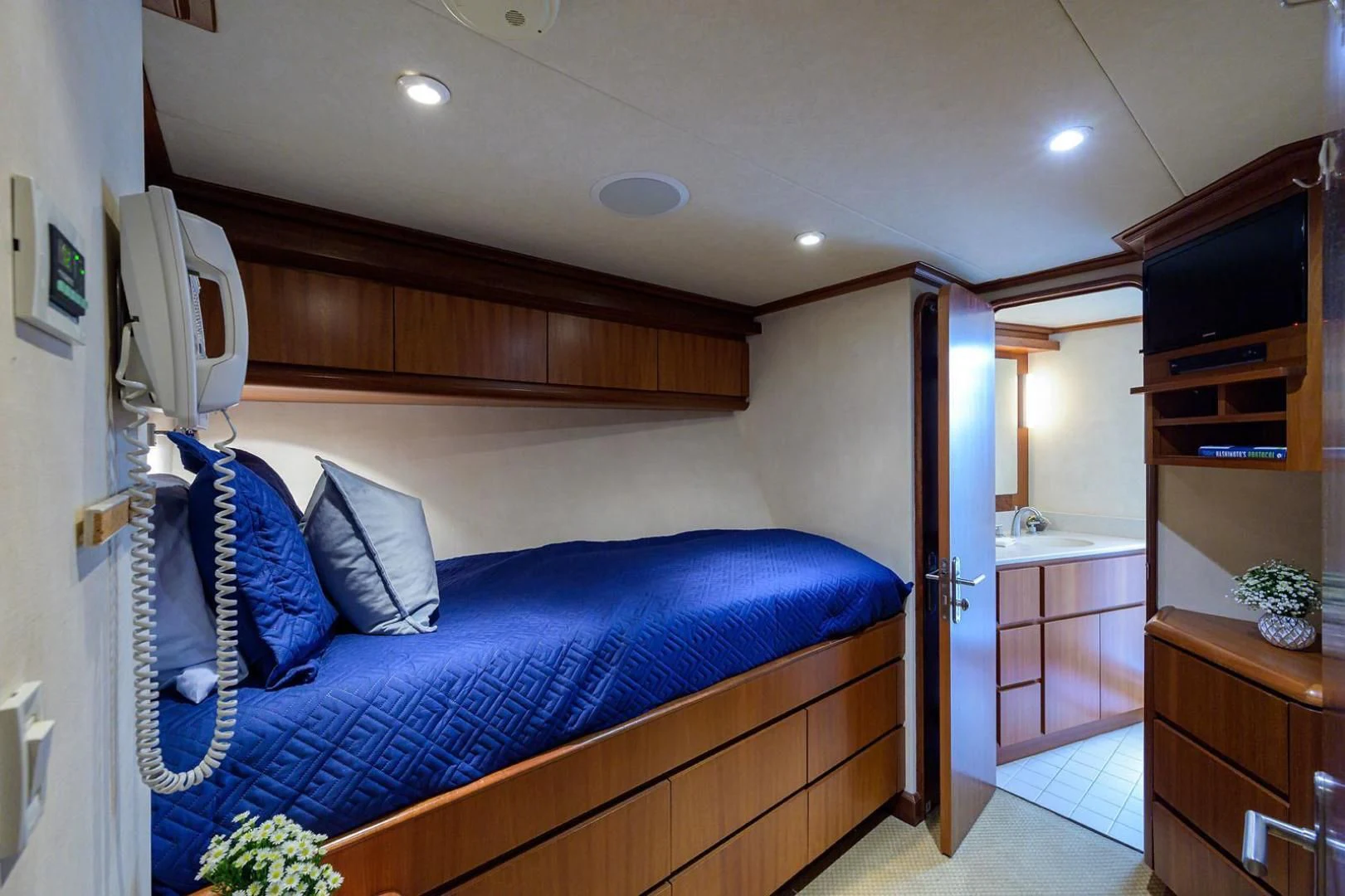 a bedroom with a bed and a television aboard LEGACY Yacht for Sale