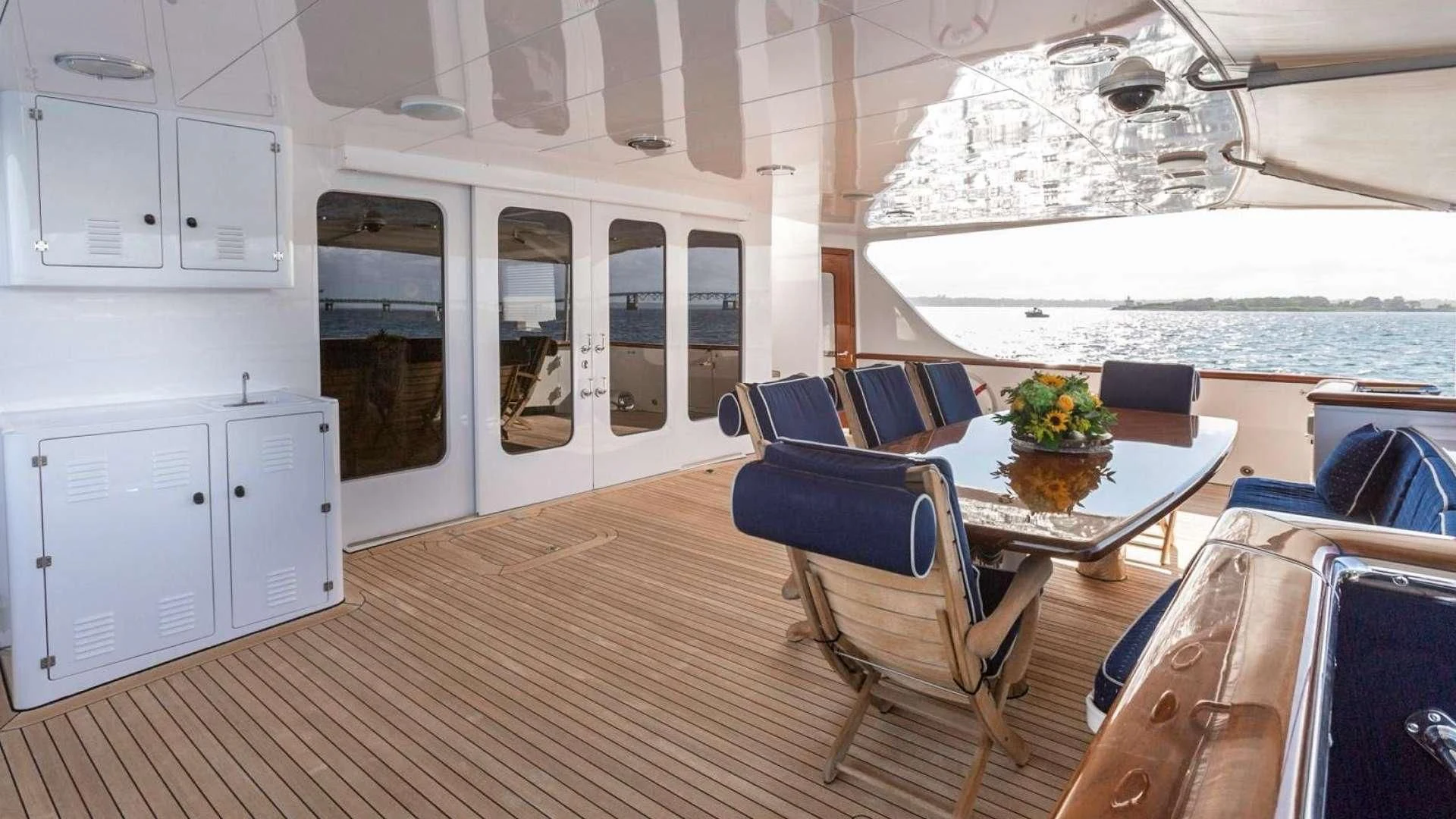 a boat with a table and chairs aboard LEGACY Yacht for Sale