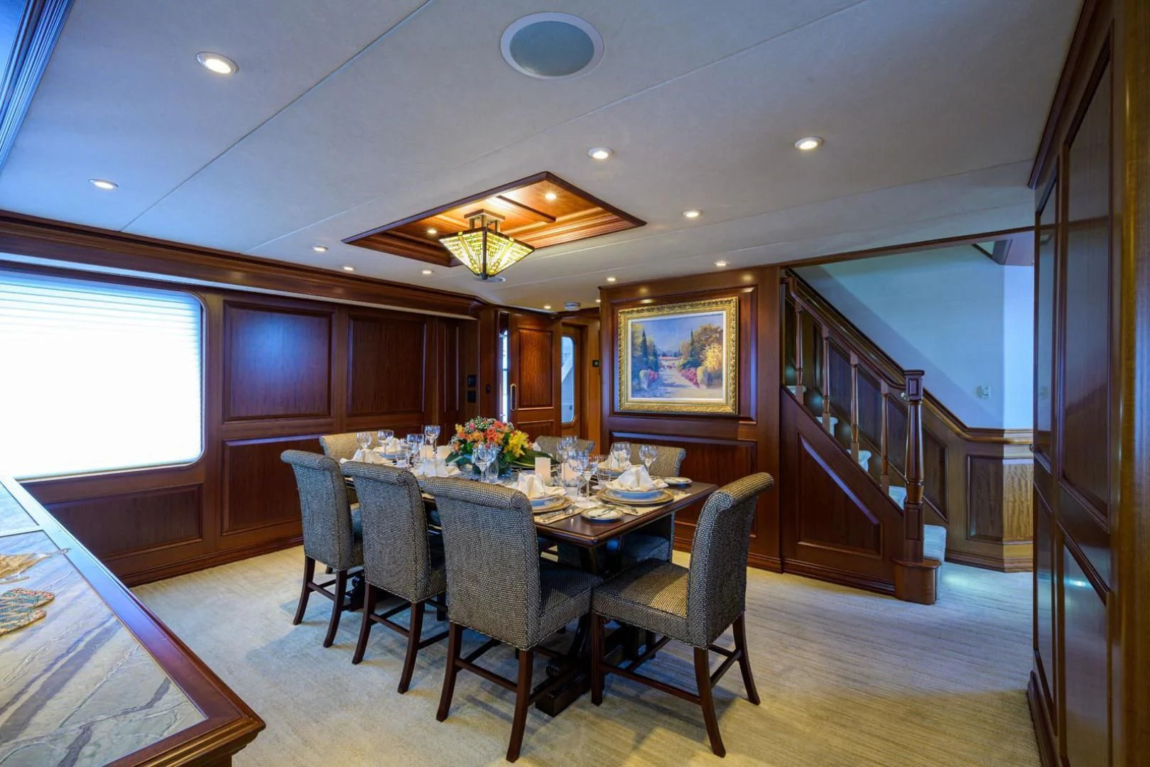 a dining room with a table and chairs aboard LEGACY Yacht for Sale