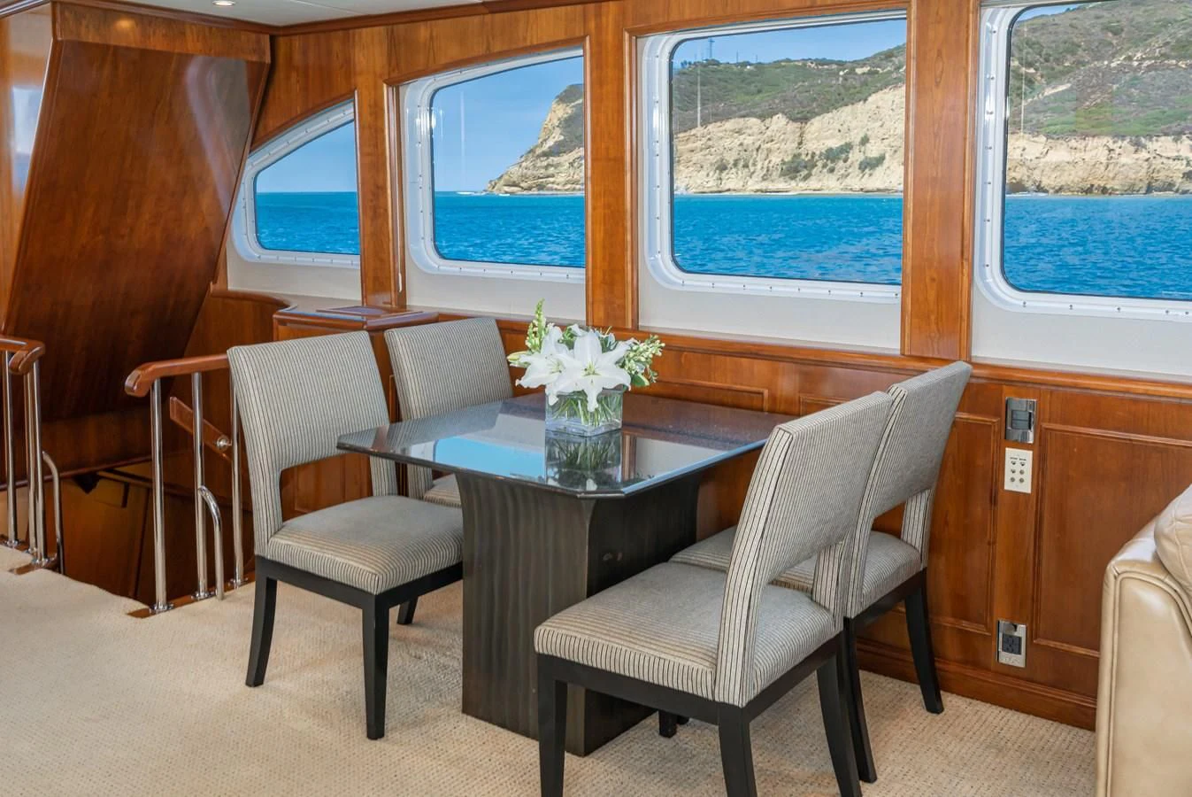a table and chairs in a room aboard LONE WOLF Yacht for Sale