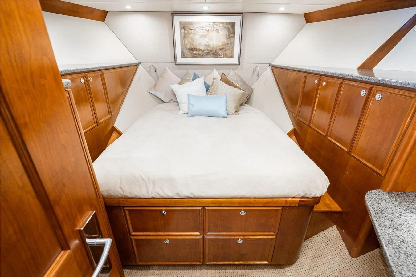a bed with white sheets and pillows aboard LONE WOLF Yacht for Sale