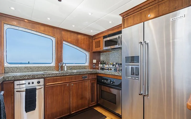 a kitchen with stainless steel appliances aboard LONE WOLF Yacht for Sale