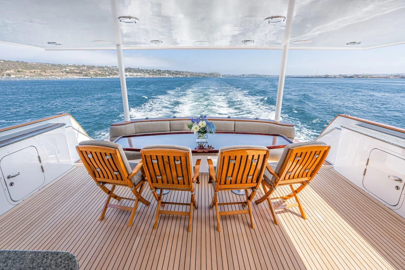 a group of chairs on a deck overlooking the ocean aboard LONE WOLF Yacht for Sale