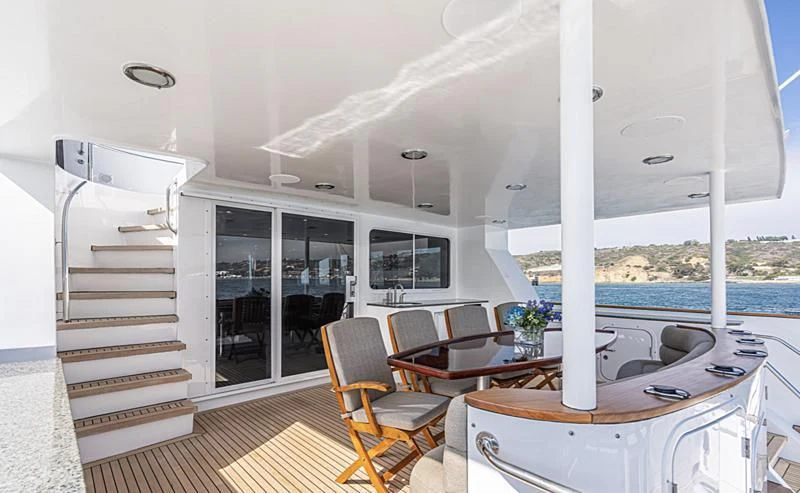 a room with a table chairs and a large window aboard LONE WOLF Yacht for Sale