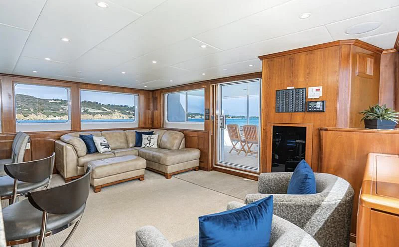 a living room with a fireplace aboard LONE WOLF Yacht for Sale