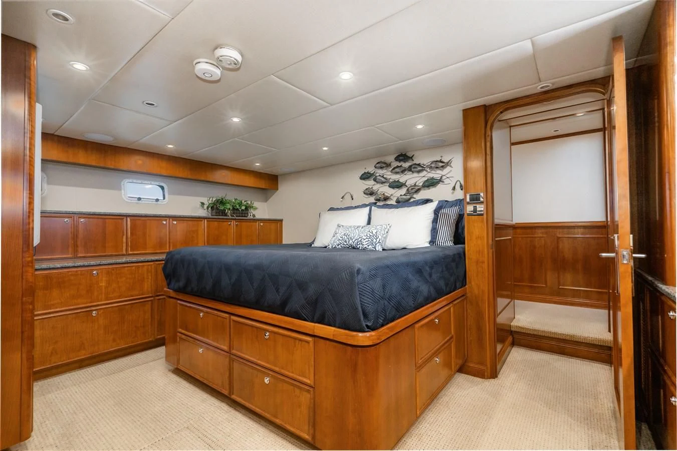 a bedroom with a bed and a closet aboard LONE WOLF Yacht for Sale