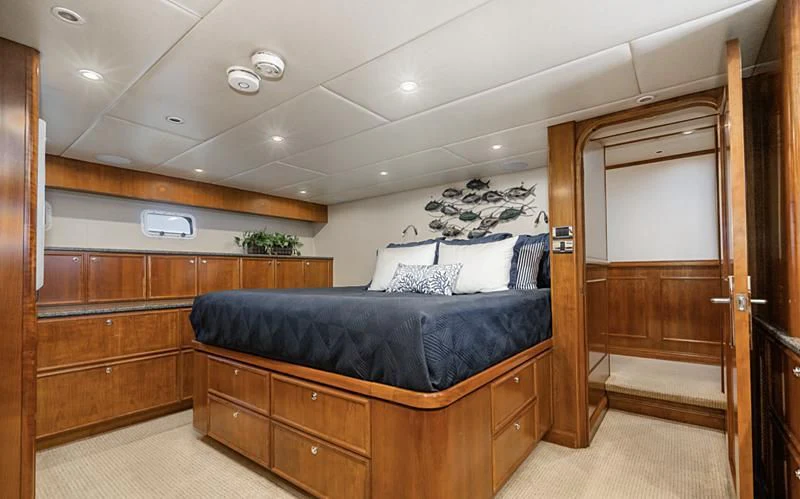 a bedroom with a bed and a desk aboard LONE WOLF Yacht for Sale