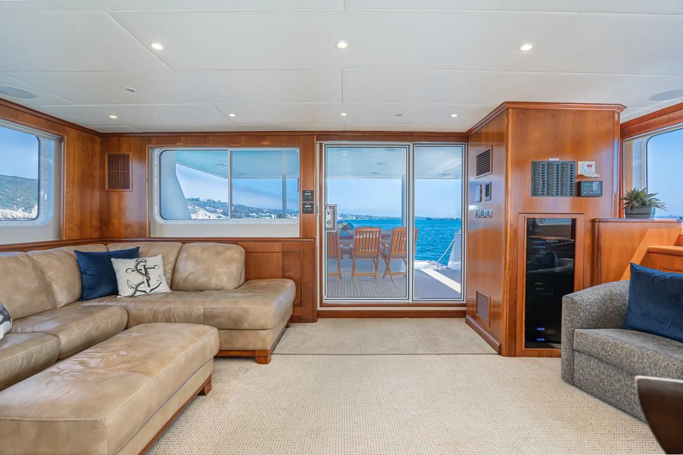 a living room with a large glass door and a fireplace aboard LONE WOLF Yacht for Sale