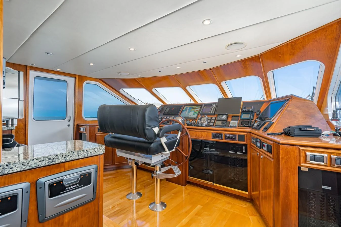 a room with a chair and a desk with computers aboard LONE WOLF Yacht for Sale