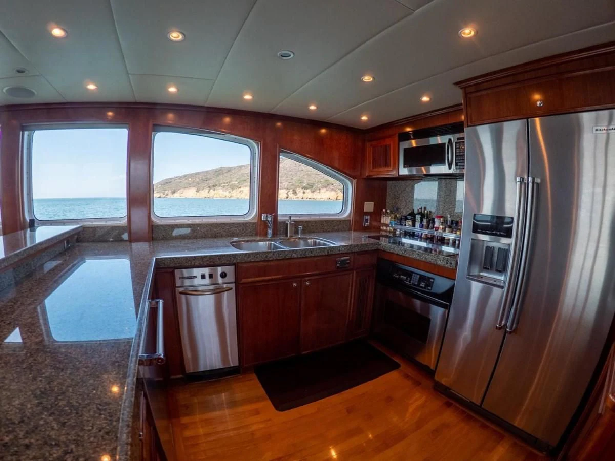 a kitchen with a stainless steel refrigerator aboard LONE WOLF Yacht for Sale