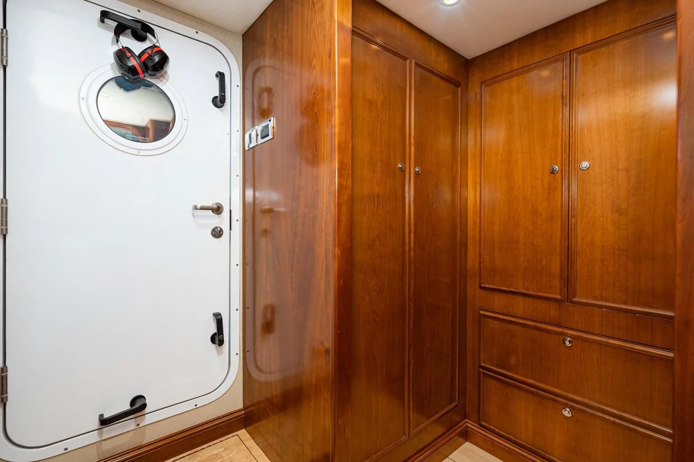 a room with wooden cabinets aboard LONE WOLF Yacht for Sale