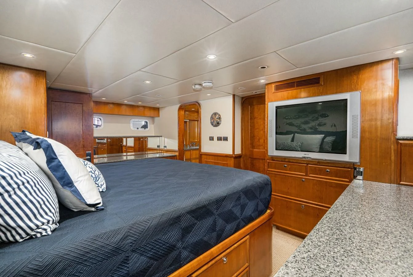a bedroom with a bed and tv aboard LONE WOLF Yacht for Sale