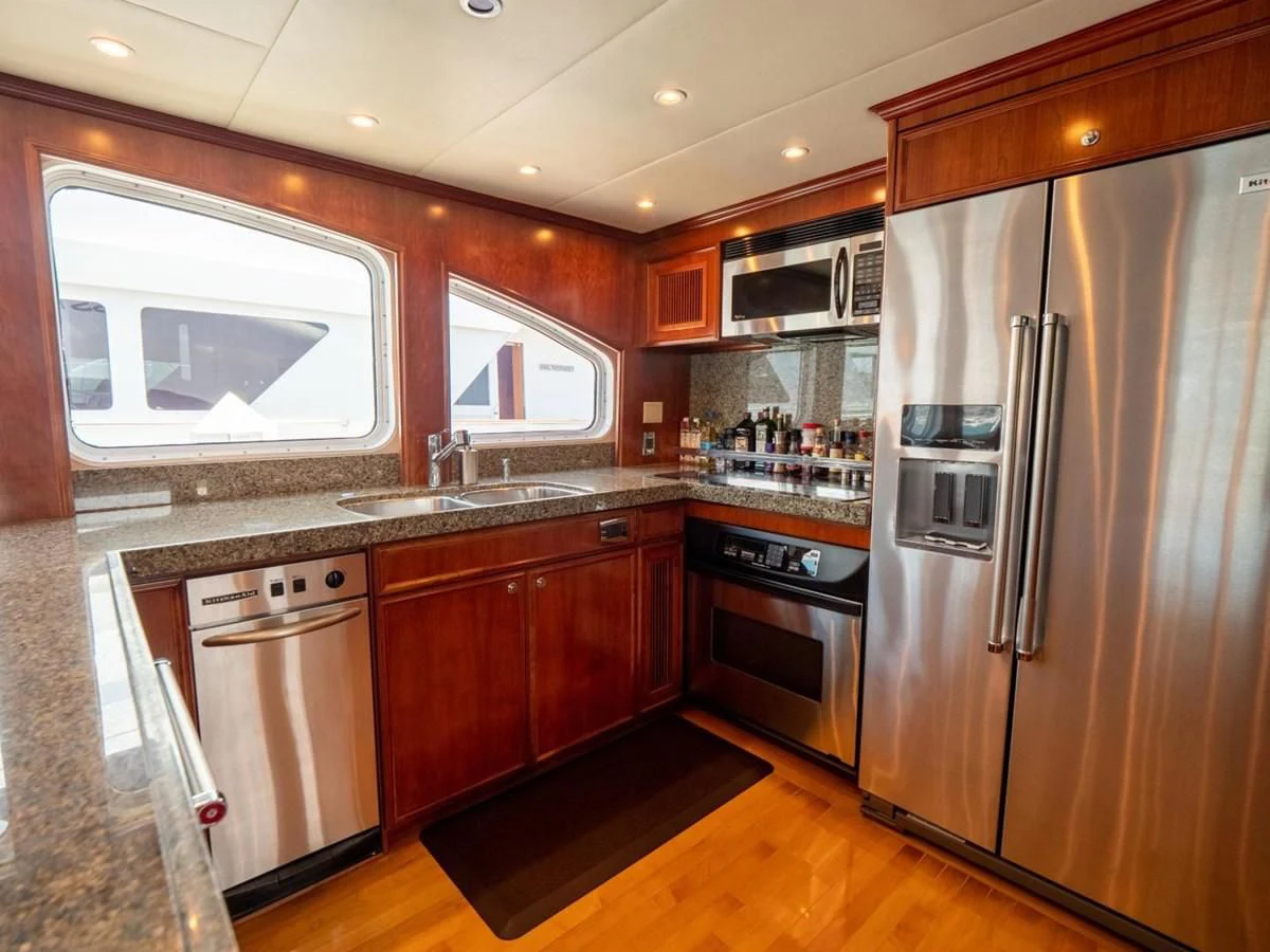 a kitchen with wooden cabinets aboard LONE WOLF Yacht for Sale