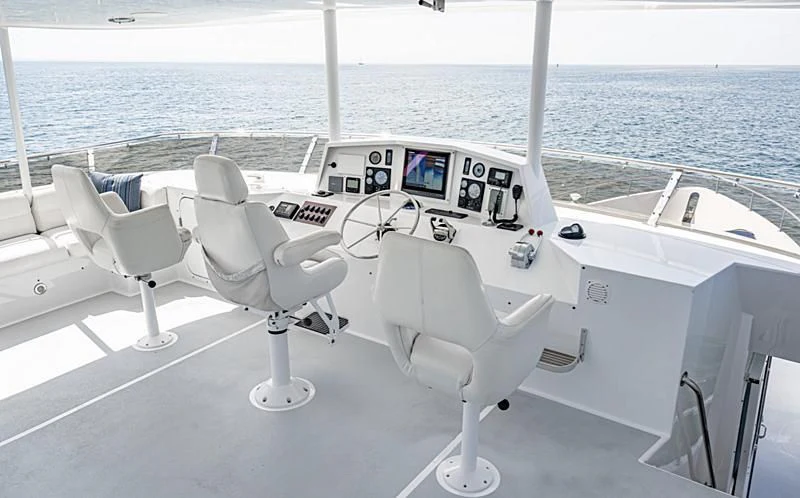 a white boat with black and white stripes on the front aboard LONE WOLF Yacht for Sale
