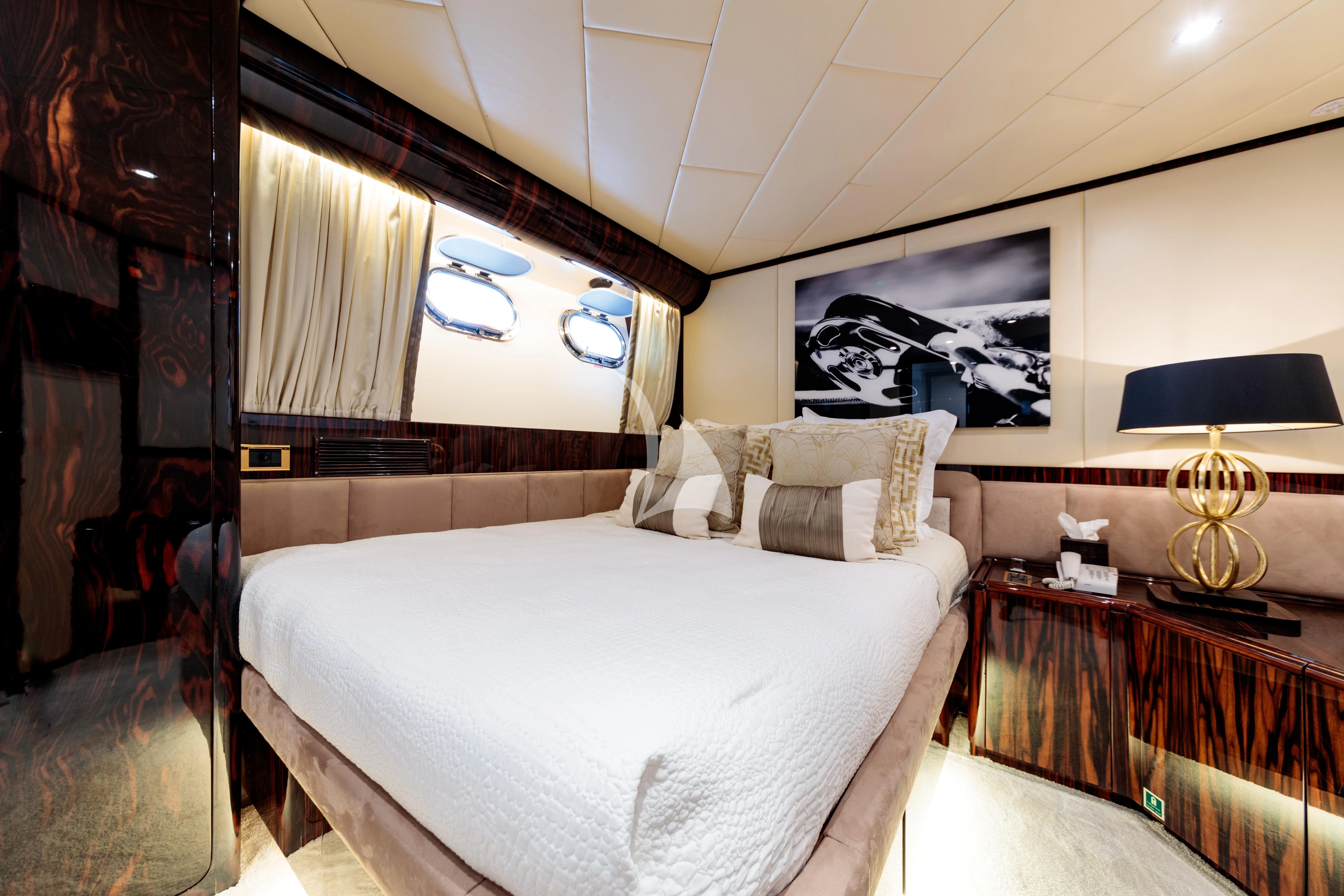a room with a bed and a window aboard HEMILEA Yacht for Charter
