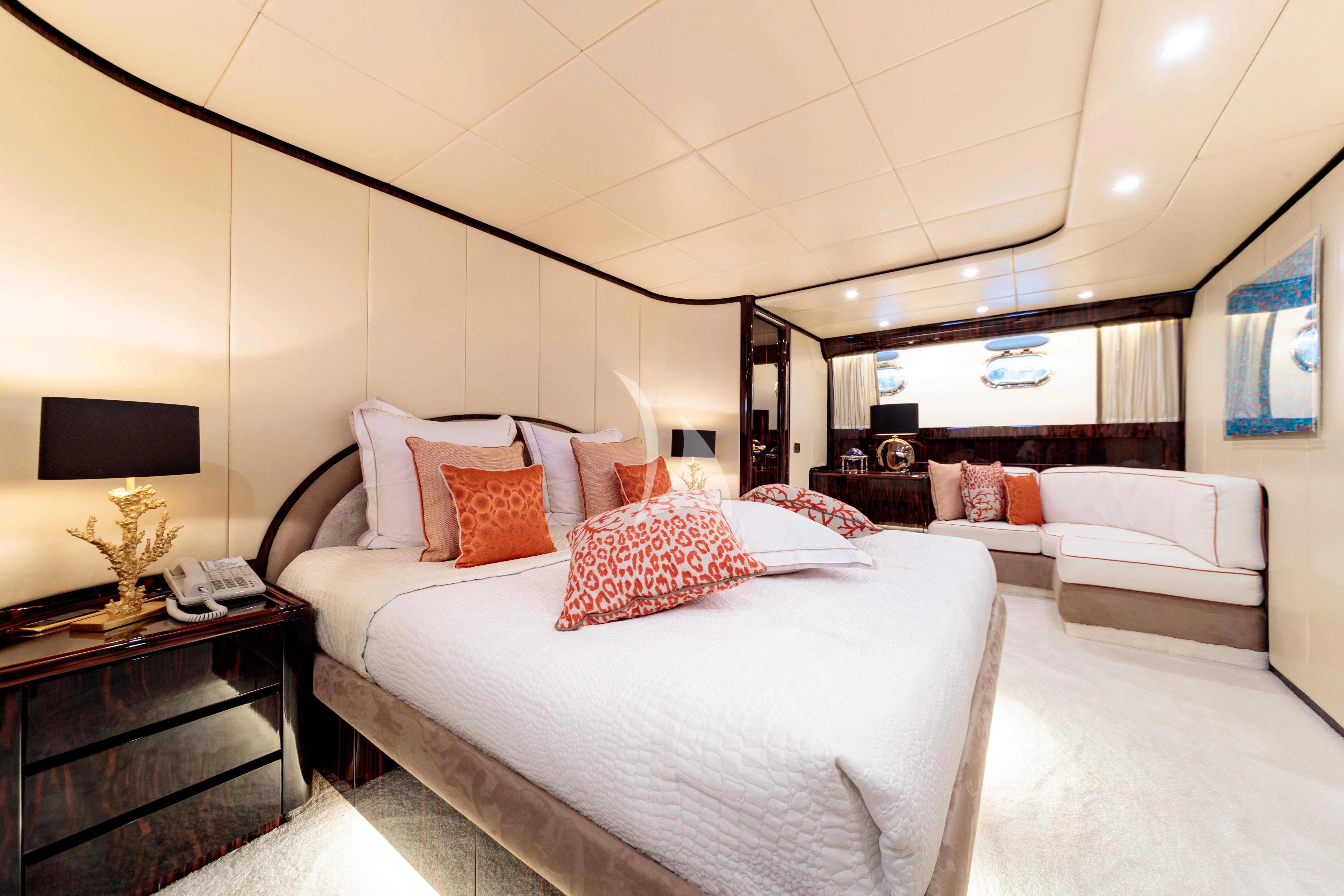 a large bedroom with a bed and a couch aboard HEMILEA Yacht for Charter