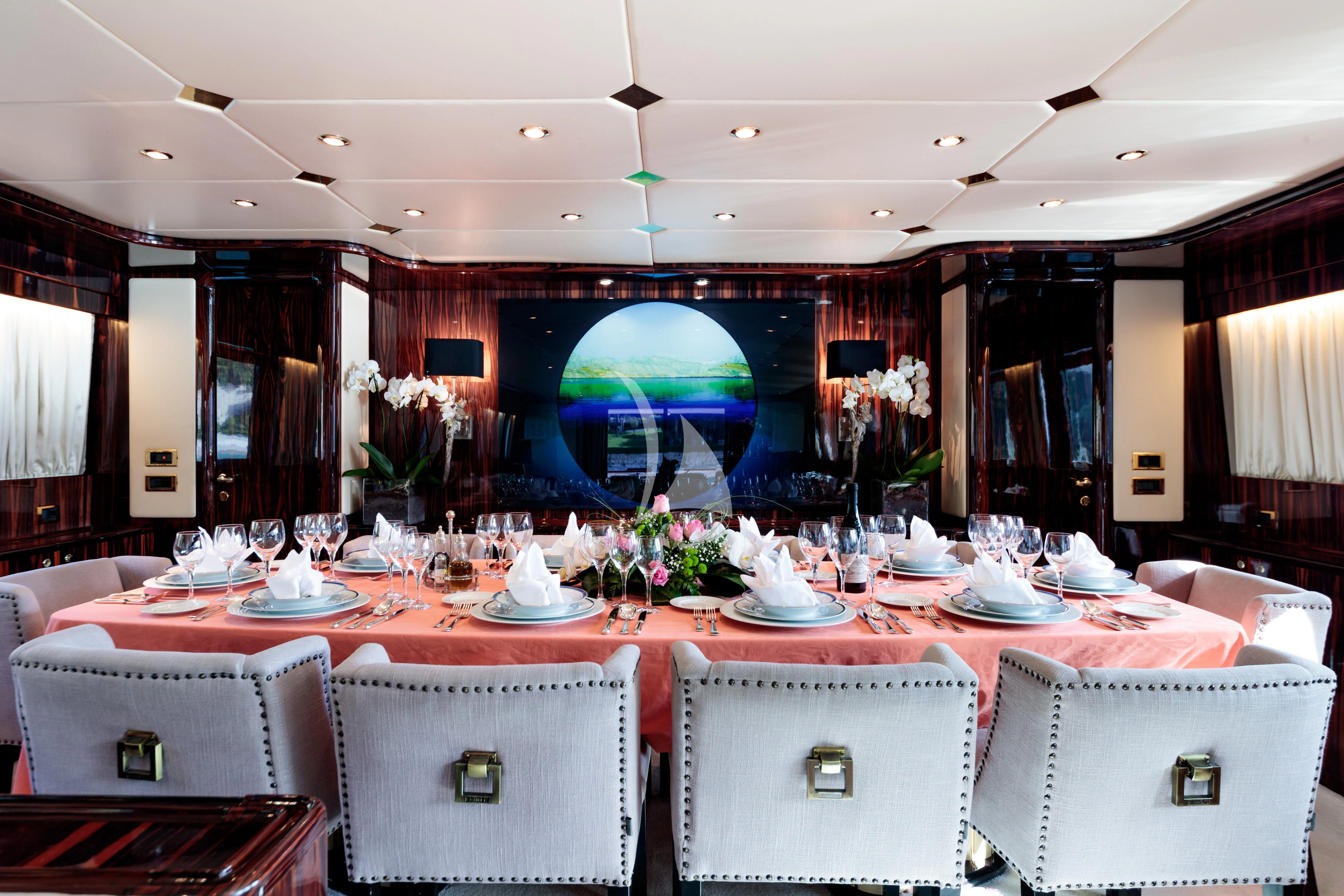a room with tables and chairs aboard HEMILEA Yacht for Charter