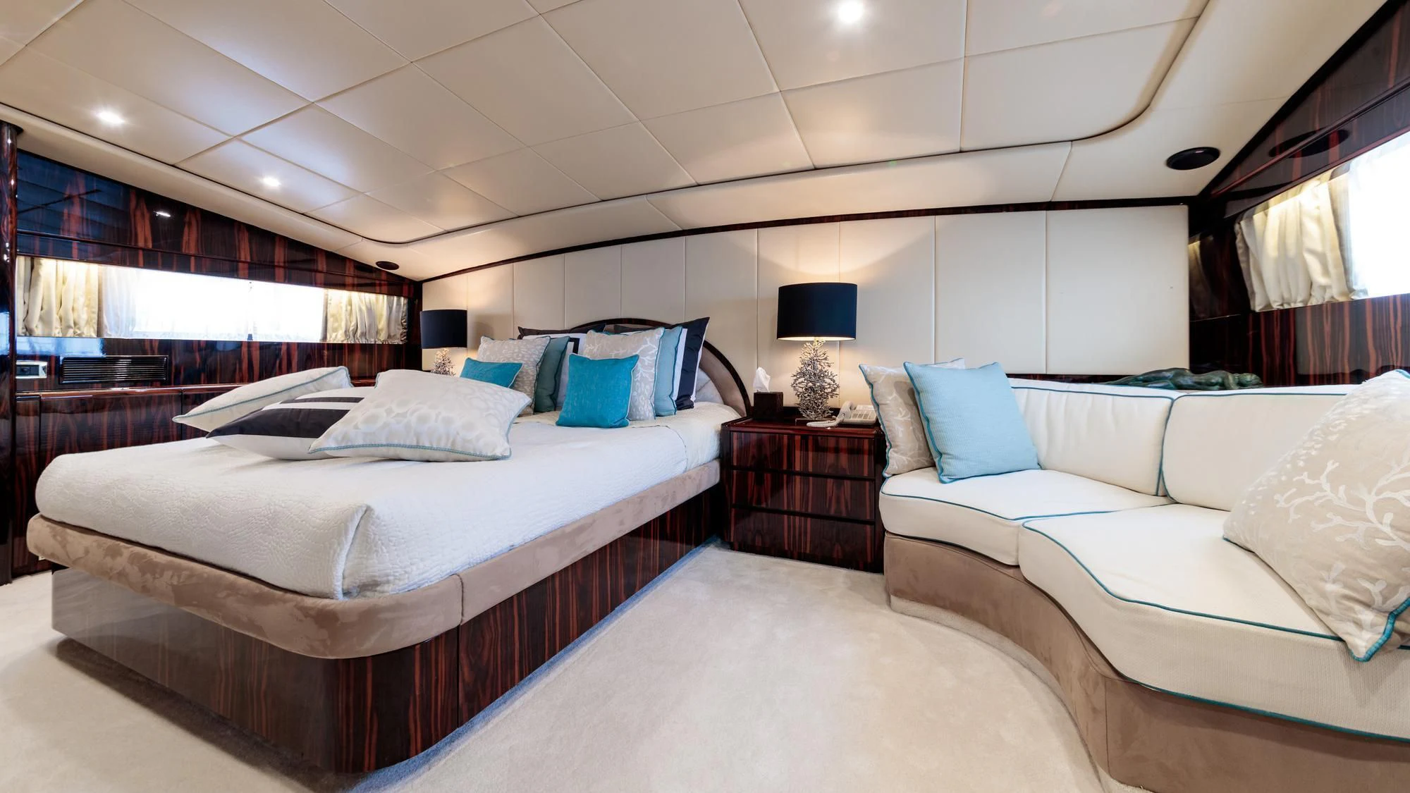 a room with a bed and a couch aboard HEMILEA Yacht for Charter