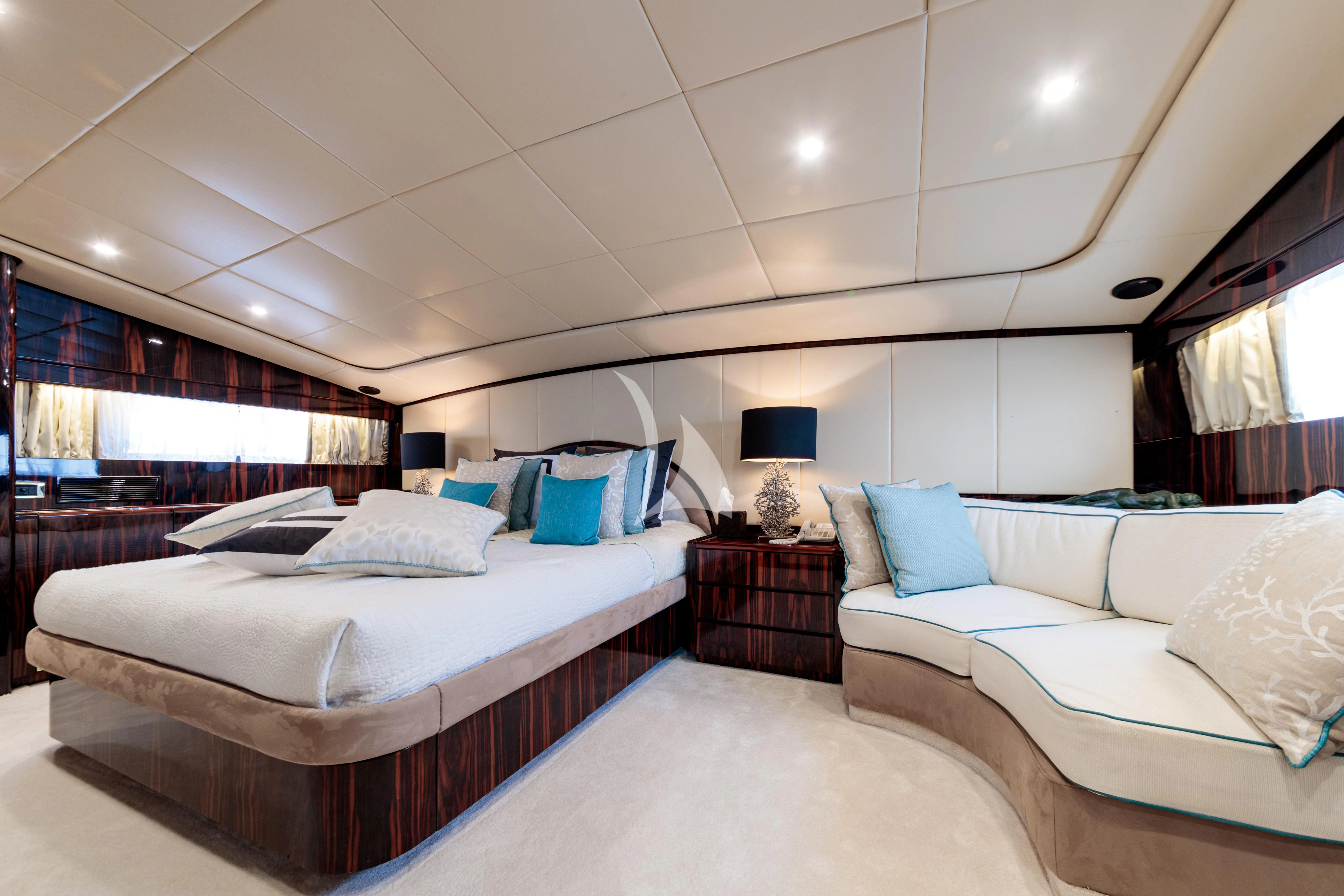 a room with a bed and a couch aboard HEMILEA Yacht for Charter