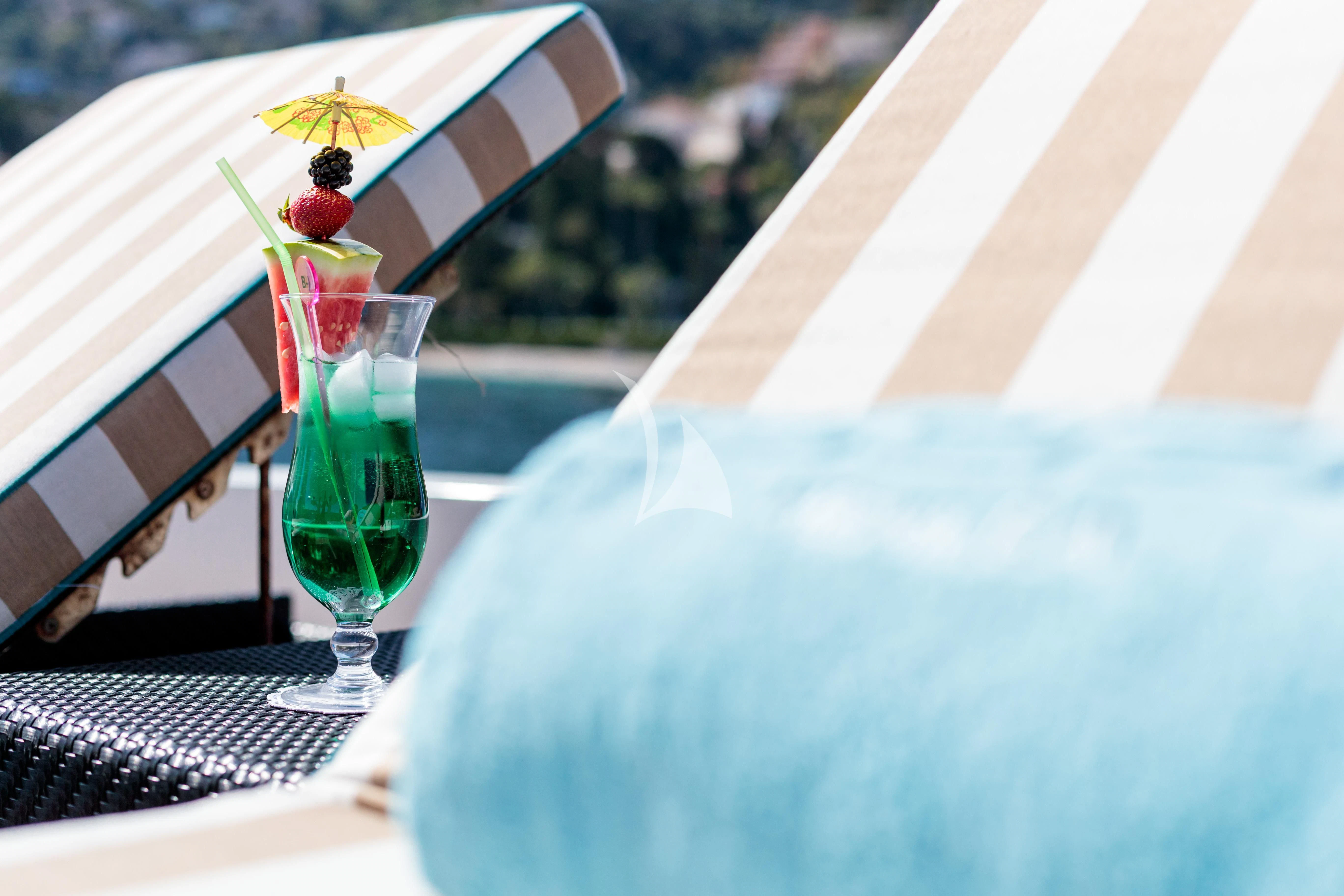 a glass of liquid on a table aboard HEMILEA Yacht for Charter
