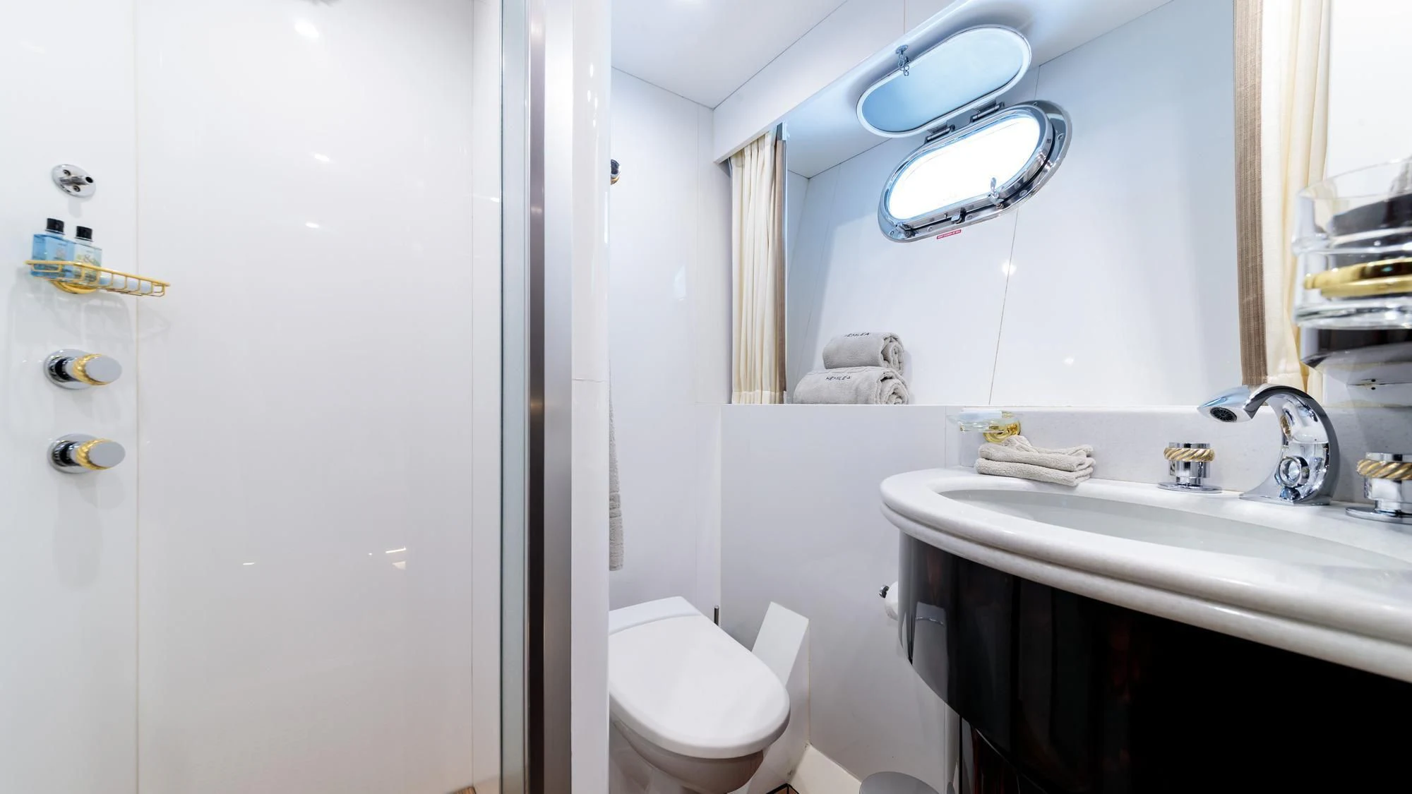 a bathroom with a sink toilet and a mirror aboard HEMILEA Yacht for Charter