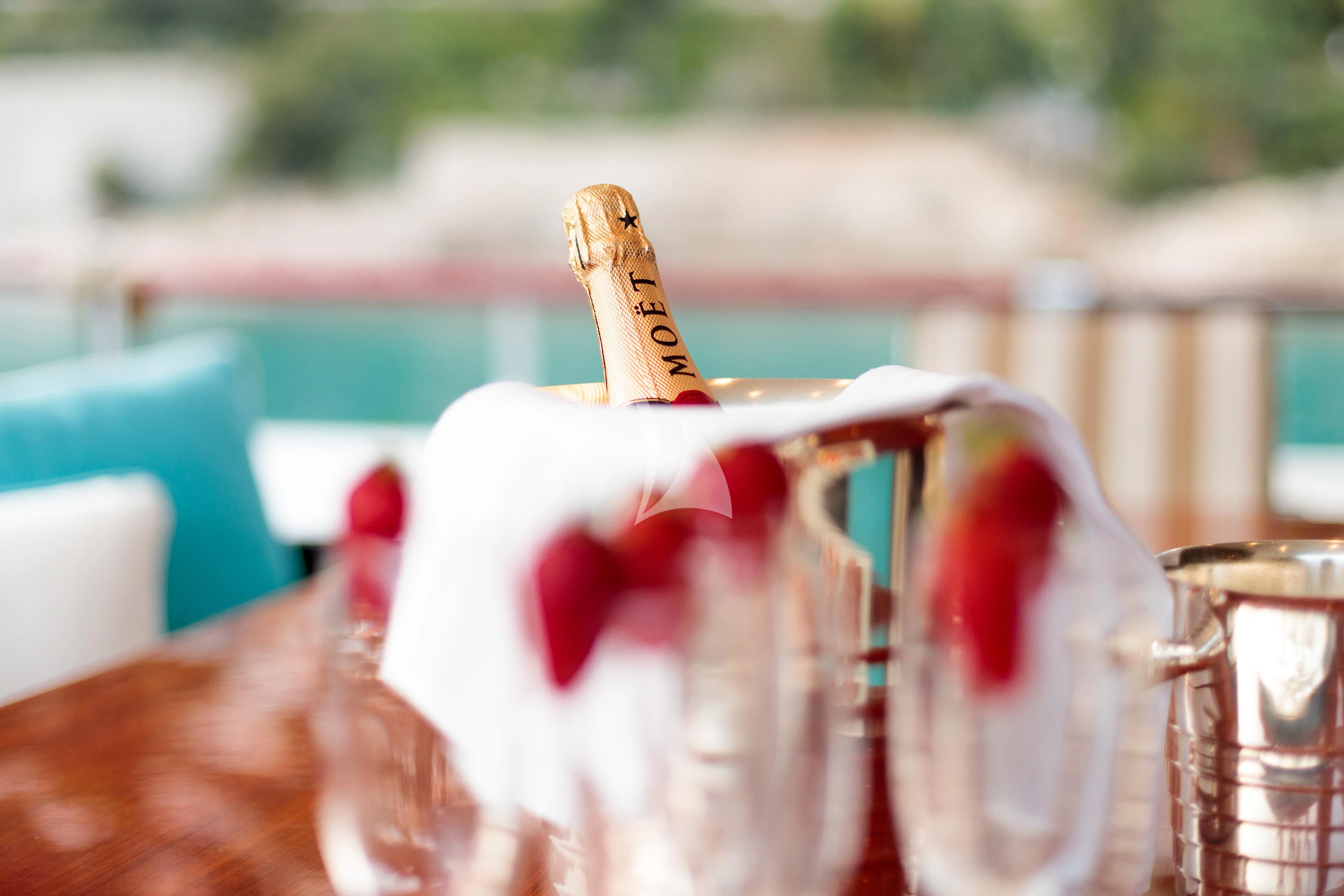 a glass bottle with a red label aboard HEMILEA Yacht for Charter