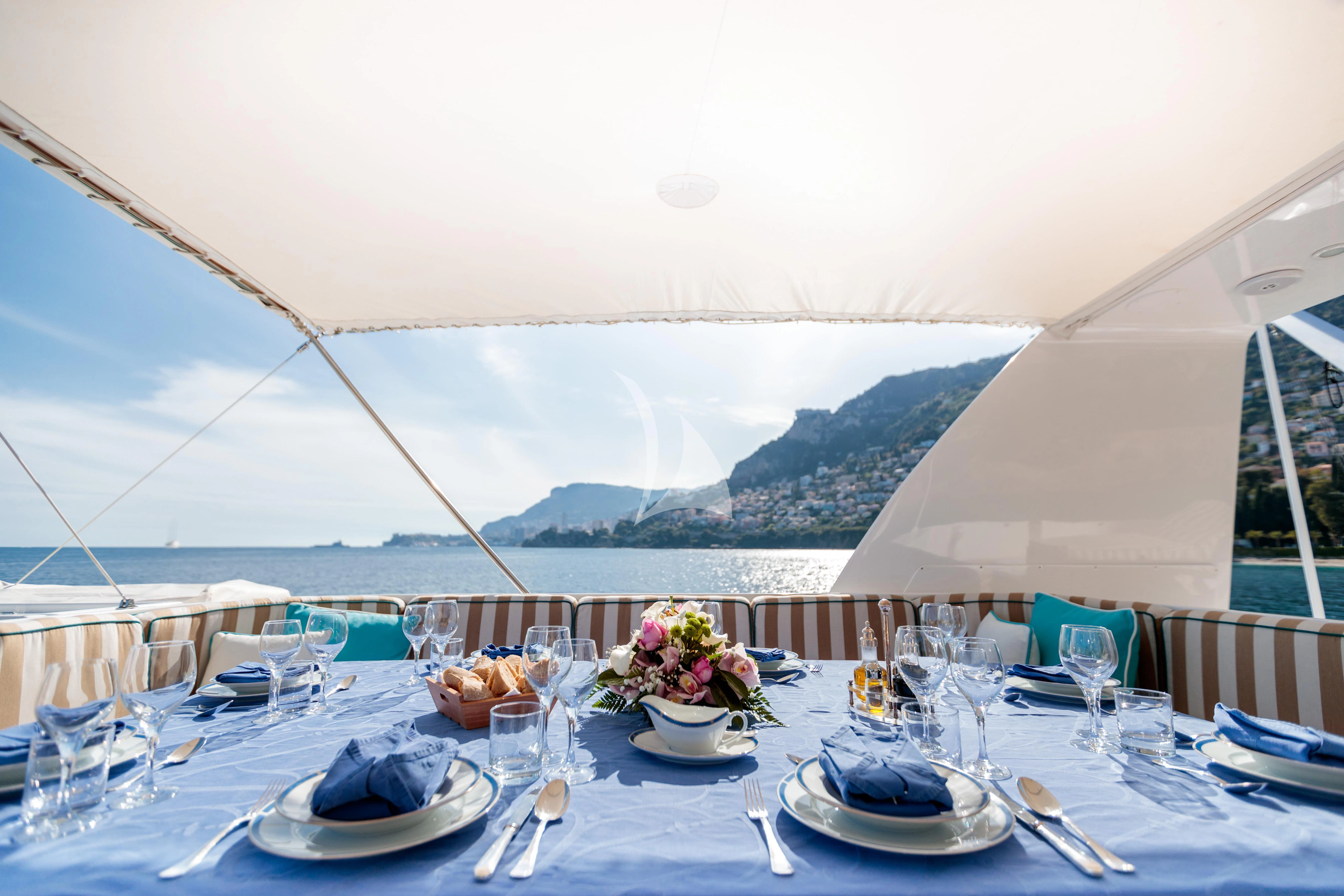 a table set for a dinner aboard HEMILEA Yacht for Charter