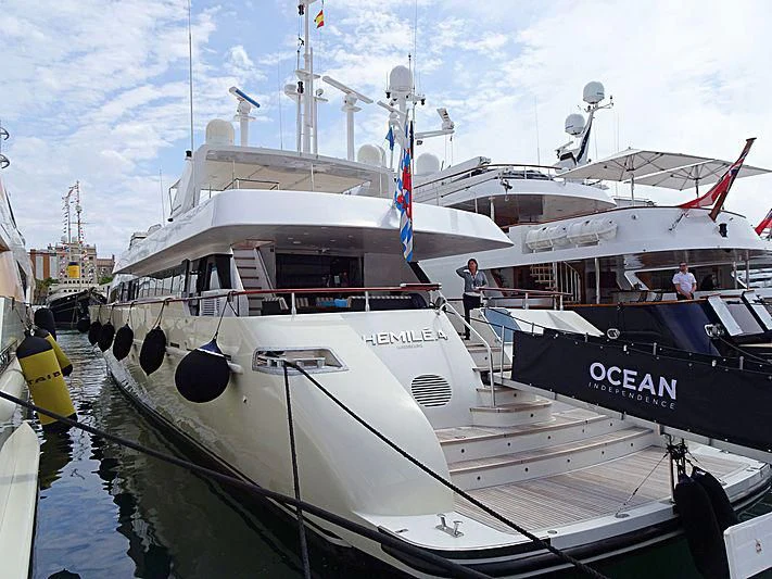 a large white boat with a flag on it aboard HEMILEA Yacht for Charter