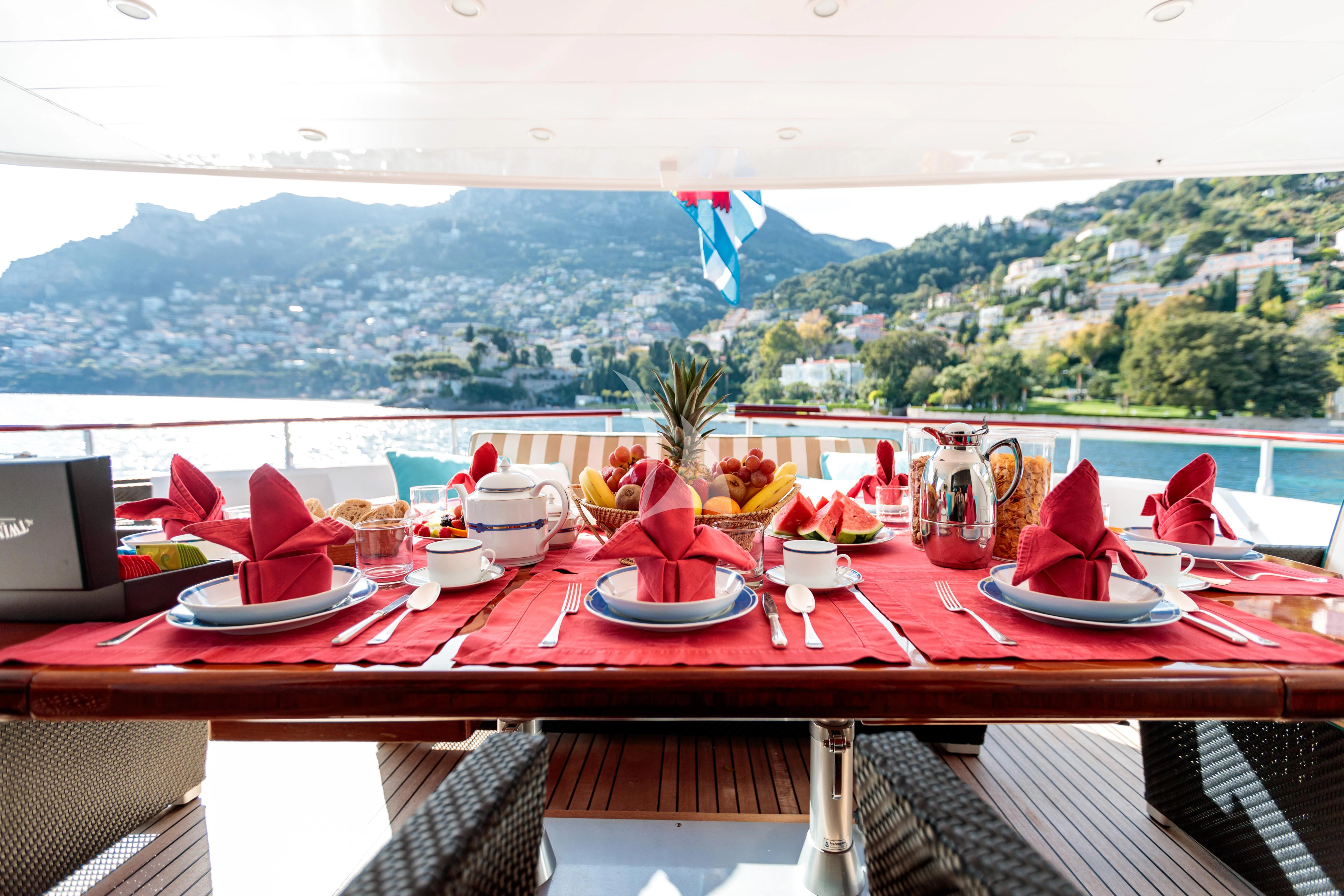 a table with plates and cups on it aboard HEMILEA Yacht for Charter