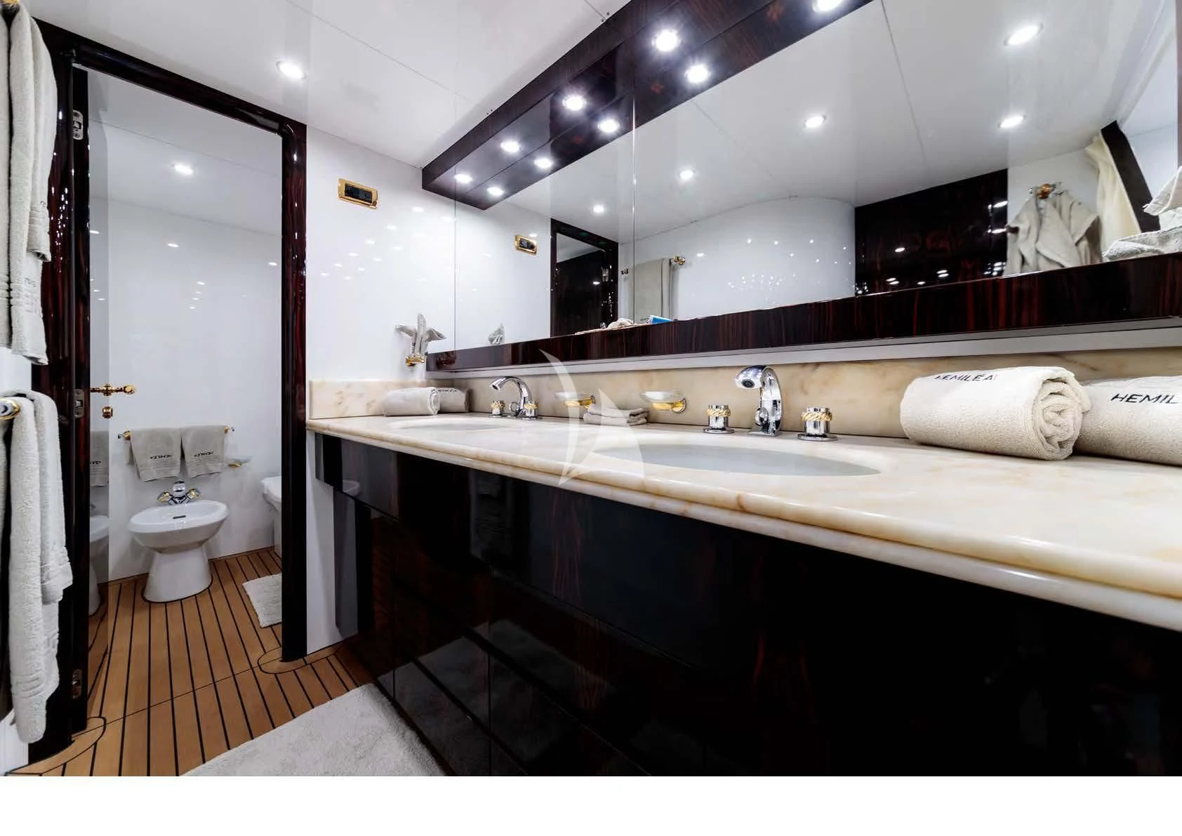 a bathroom with a large mirror aboard HEMILEA Yacht for Charter
