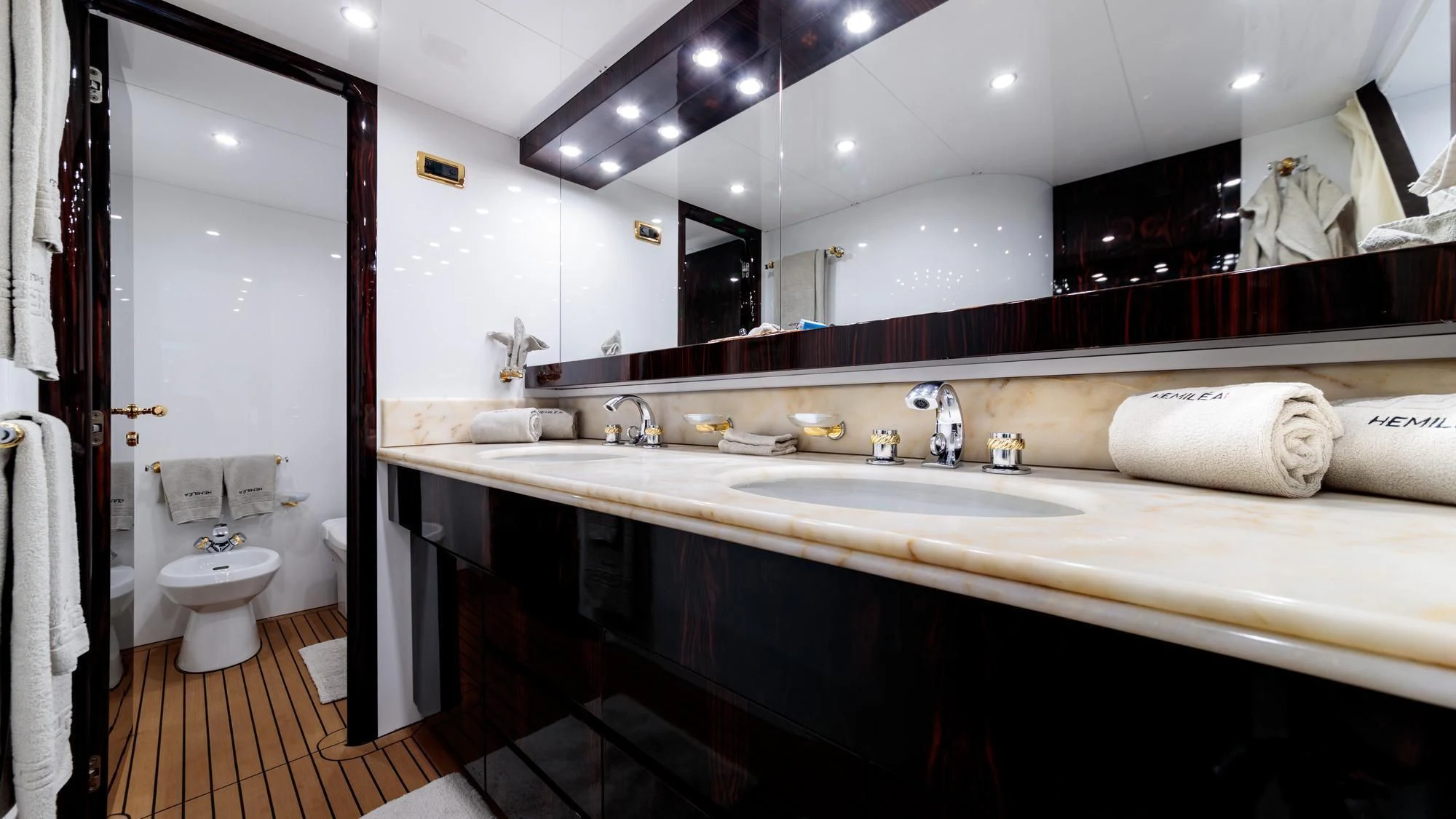 a bathroom with a large mirror aboard HEMILEA Yacht for Charter