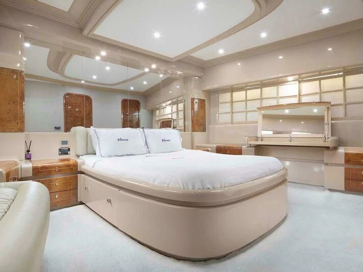 a large bedroom with a large bed aboard BLANCO Yacht for Sale