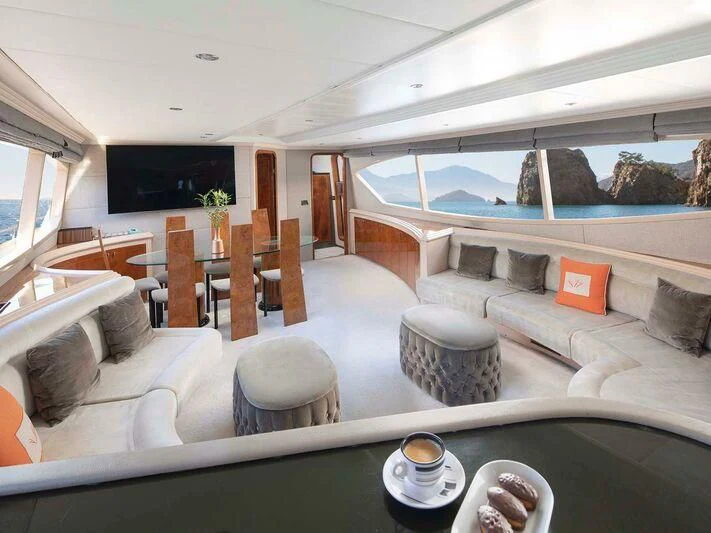 a living room with a large glass window and a large swimming pool aboard BLANCO Yacht for Sale
