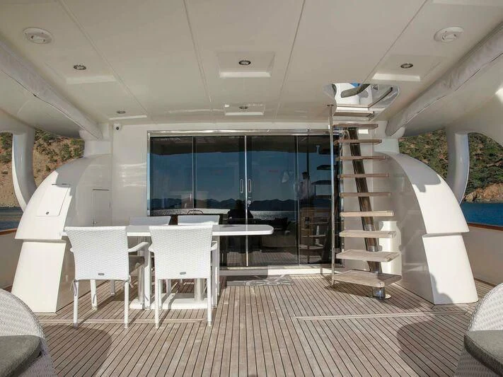a room with a staircase and a table and chairs aboard BLANCO Yacht for Sale